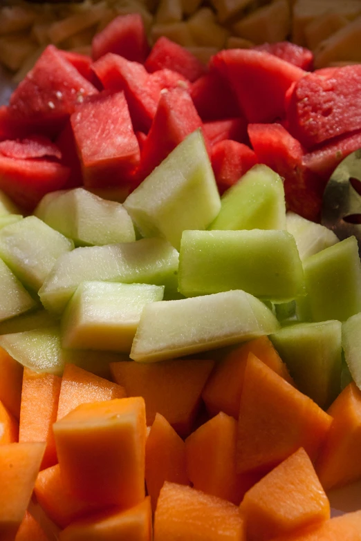 there is a white plate with sliced and chopped vegetables