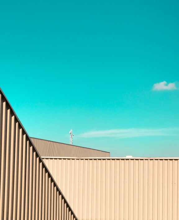 a airplane is in the sky above a wall