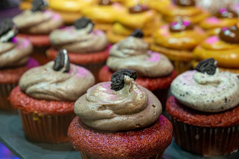 a close up of a table with cupcakes and cakes