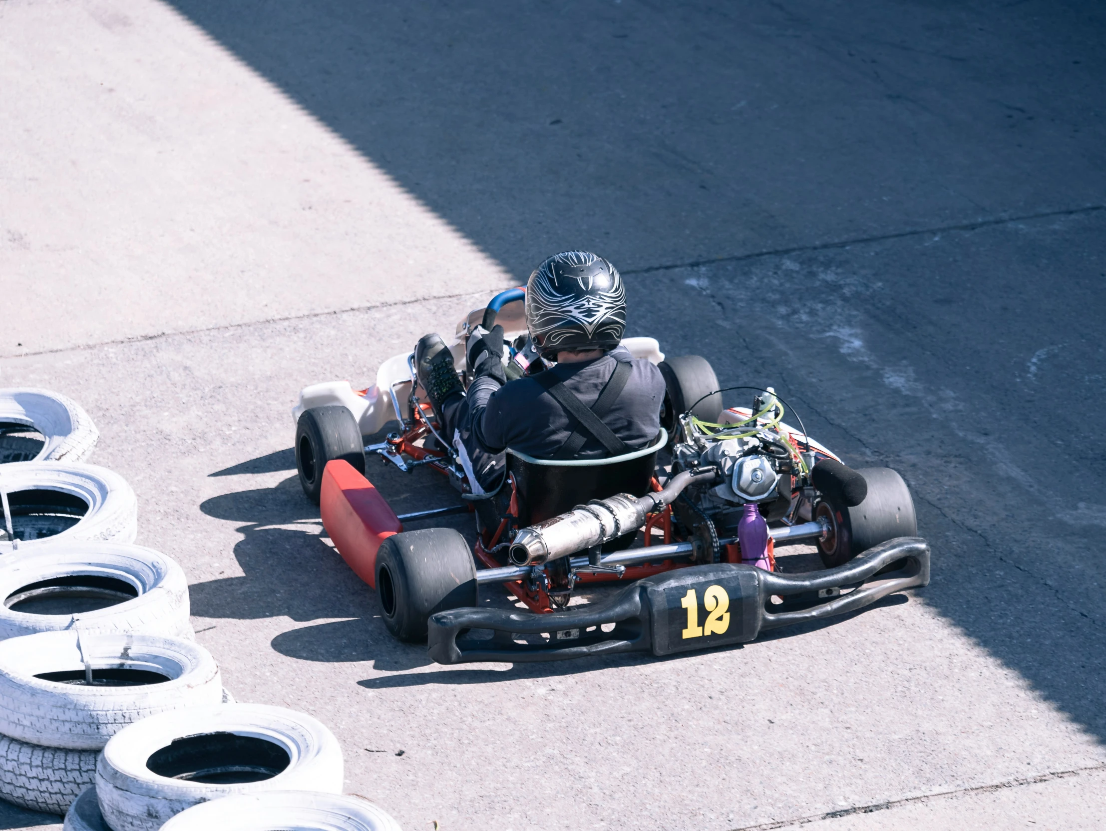 a guy in a go - cart that is going down the street