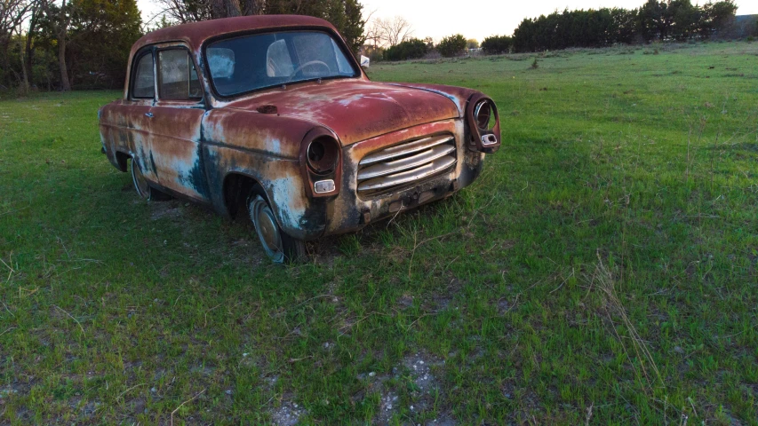 an old rusted truck in a grassy field