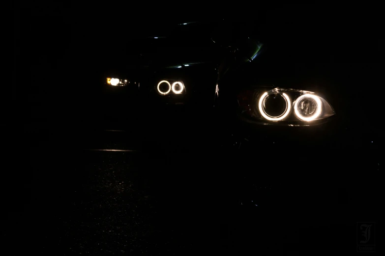 a car driving at night under lights in the dark