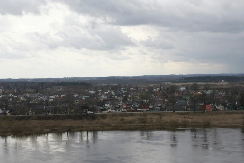 the town is next to a lake with a mountain in the background