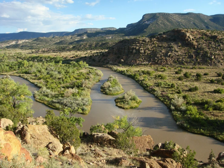 the river is winding in both directions, near the mountains