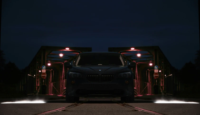 a truck parked on the side of a bridge at night