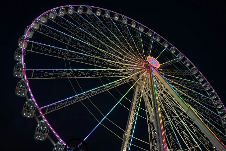 a ferris wheel is shown lit up at night