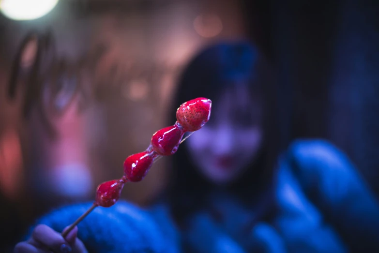 a close up of someone holding a stick filled with jelly