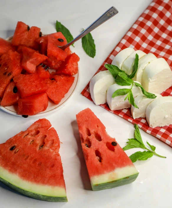 fresh cut slices of watermelon with mint on the side