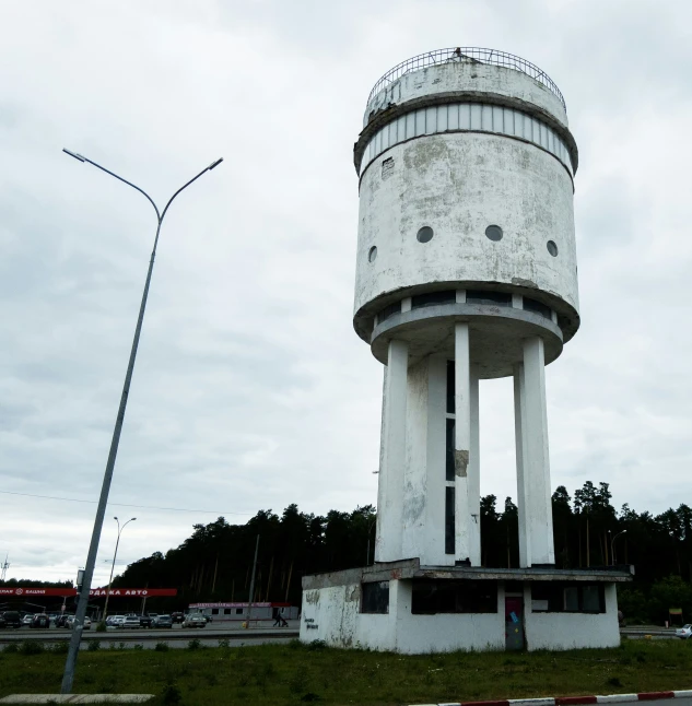 a white water tower on a city street