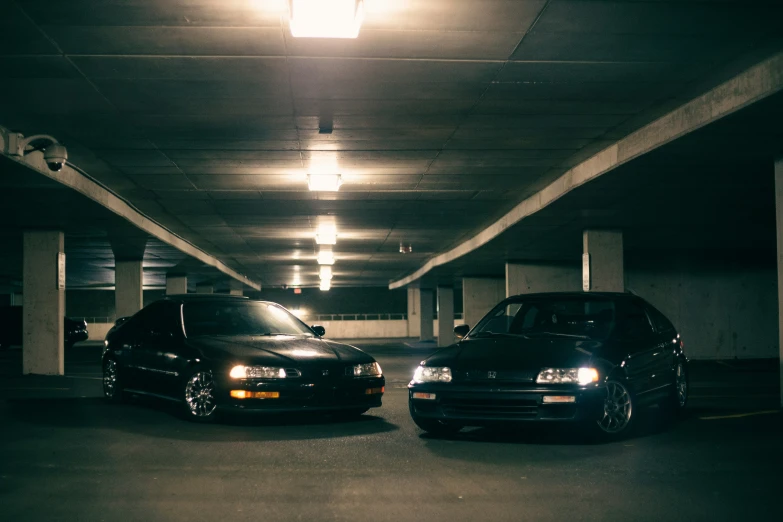 two cars are parked in a parking garage