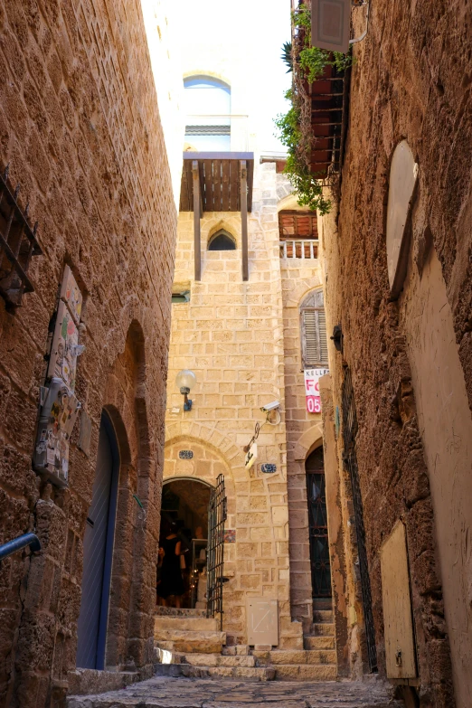 an alley way with brick buildings and steps