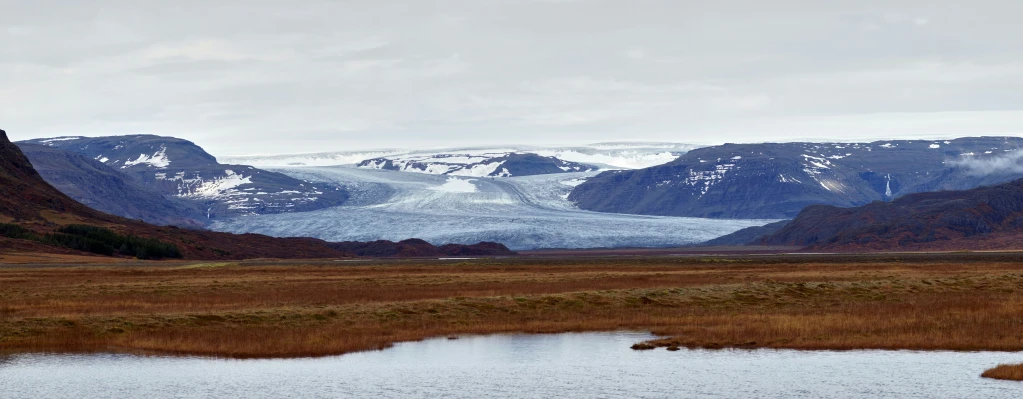 the mountain scenery is shown with small body of water