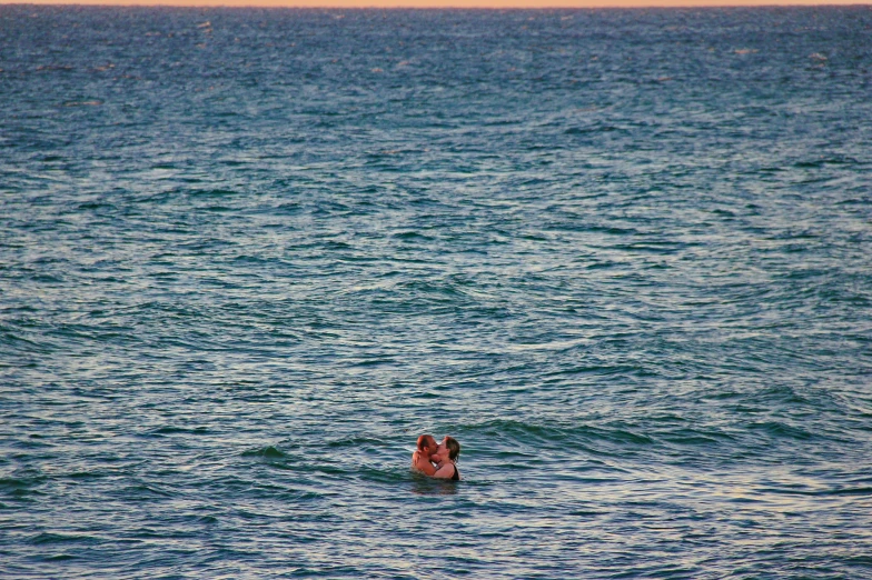 the woman is swimming alone in the ocean