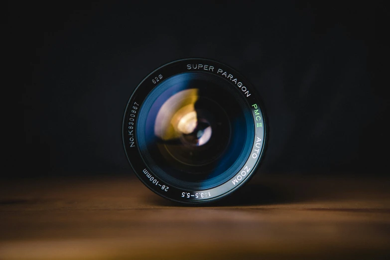 a lens on top of a table with its reflection