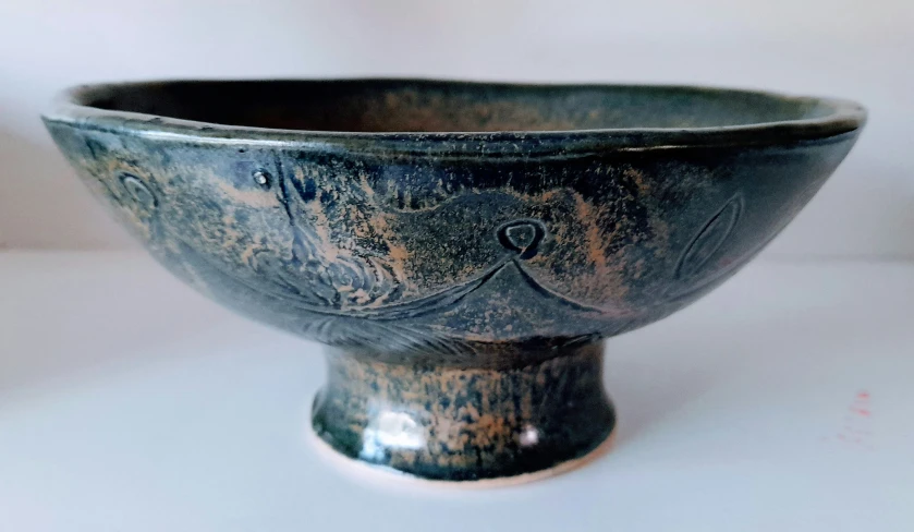 a black stone bowl sitting on a table