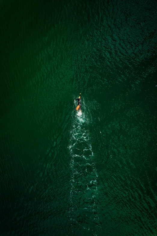 two people on small boat floating on the water