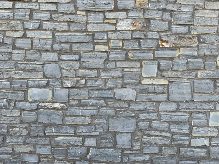 an image of a brick wall with a cat sleeping on it