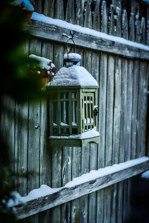 a small lantern is hanging on a wall