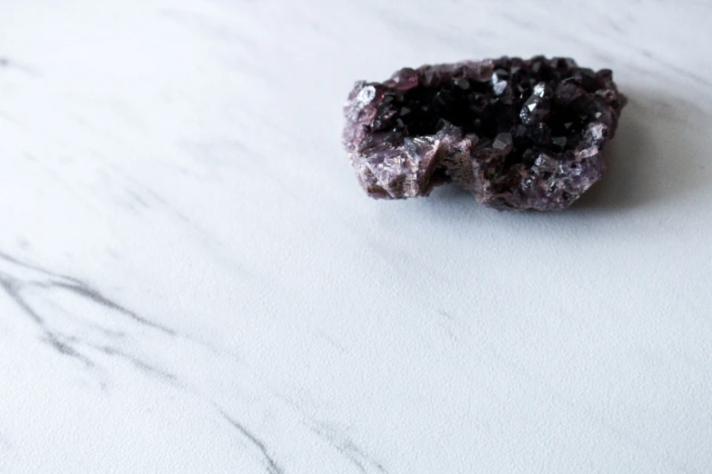 two pieces of dark blue material on a marble surface