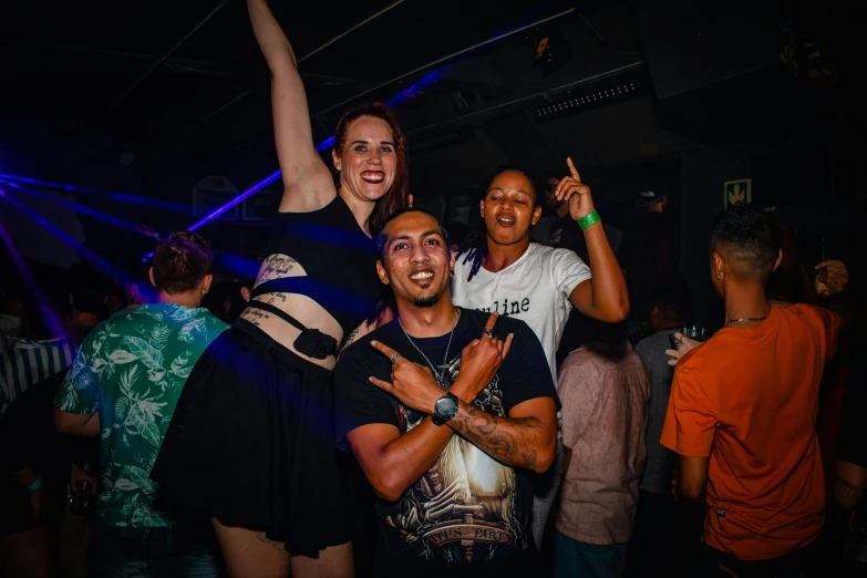 a group of people standing on top of a nightclub floor