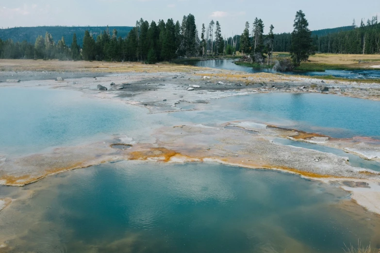 the colorfully colored waters and  springs are in a valley