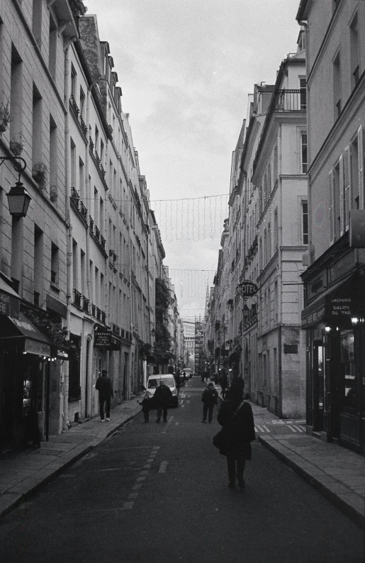 several people walk down an empty city street