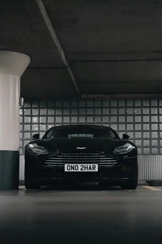 a black car is parked in a parking garage