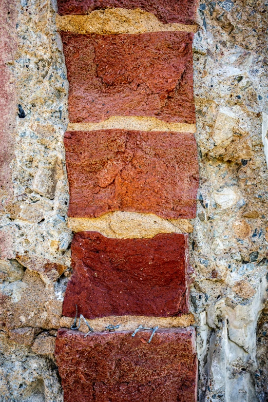 a red and yellow painting on a rock