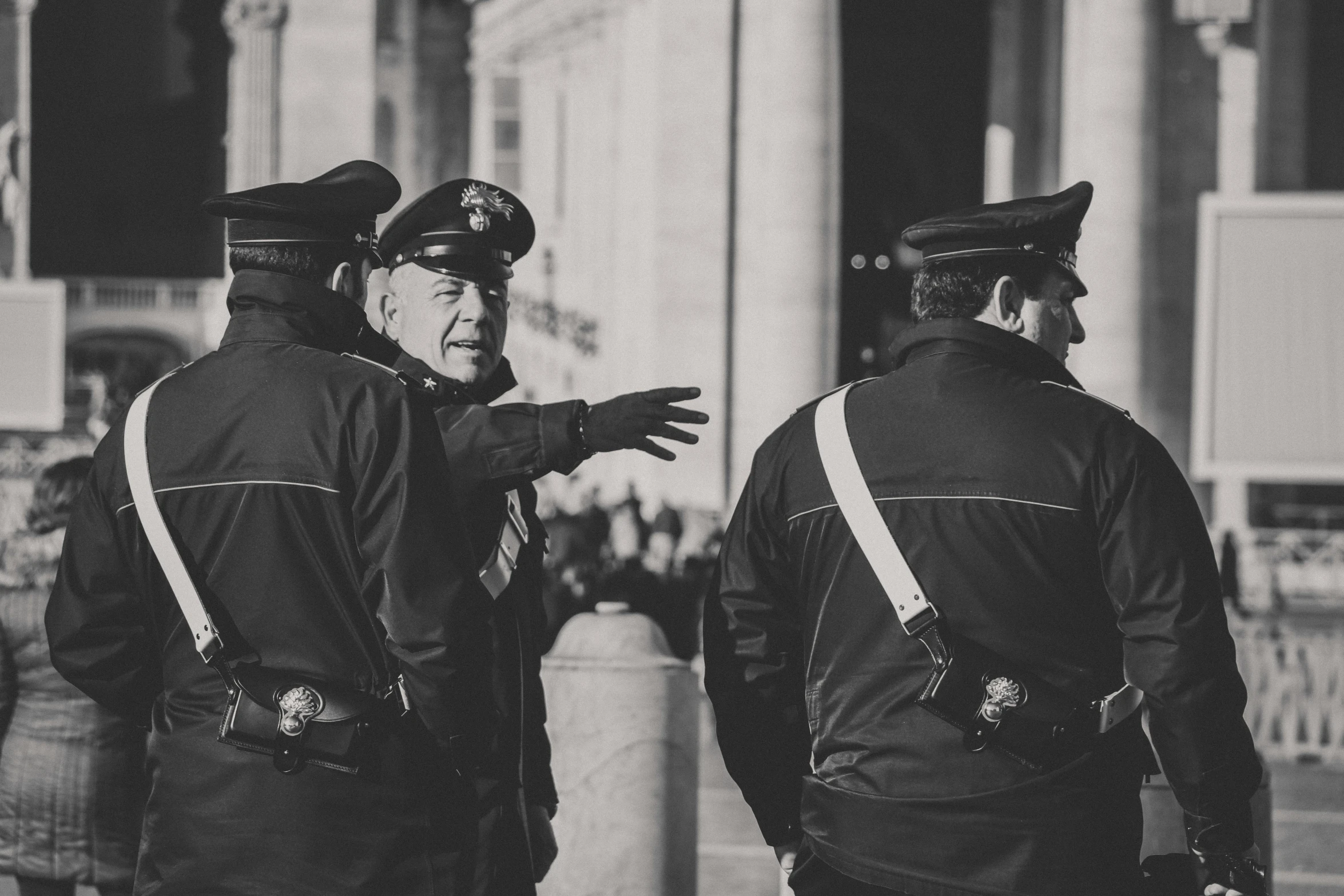 two policemen talking and talking to a crowd