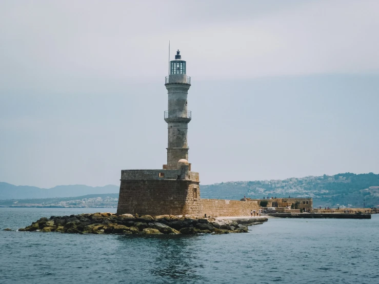 the white light house is located near the shore