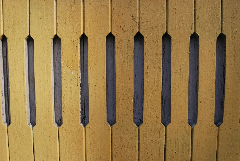 yellow fence with black iron posts as a pattern