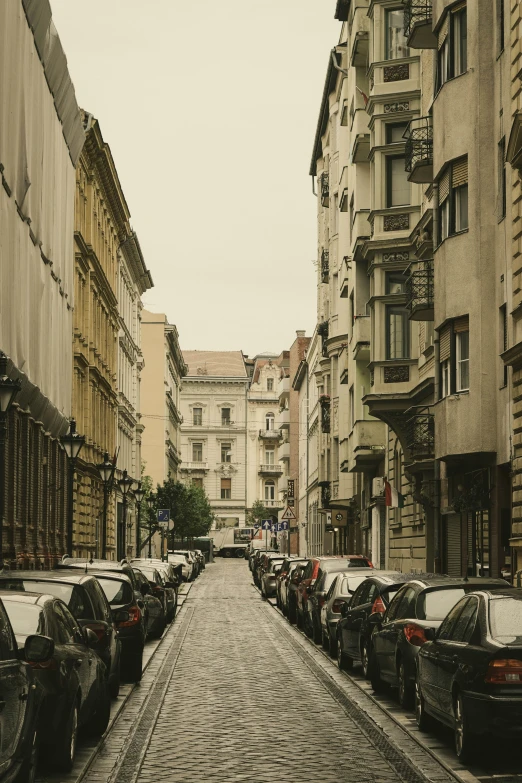 a street full of parked cars and buildings