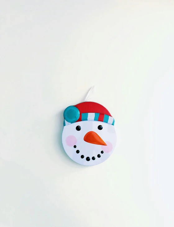 a cute ceramic ornament with a snowman's face