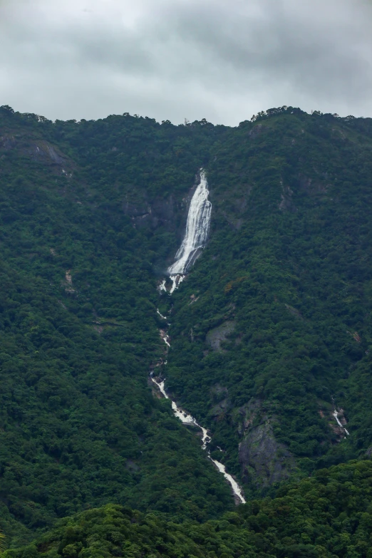 the waterfall looks like it is flowing down the mountain