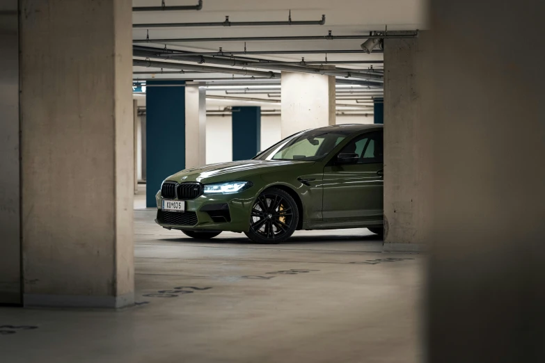 a green car parked inside of a building