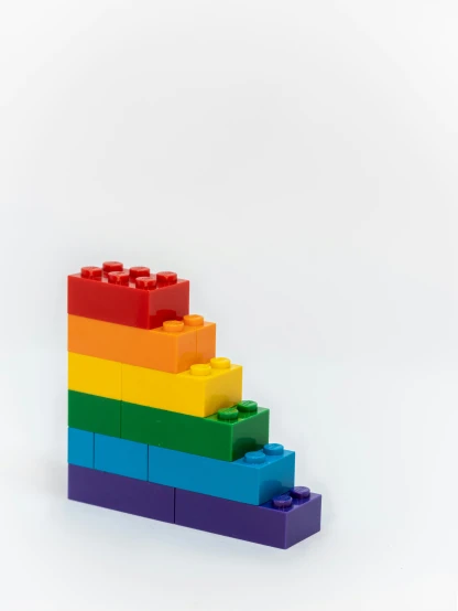 the pyramid made out of legos is against a white background