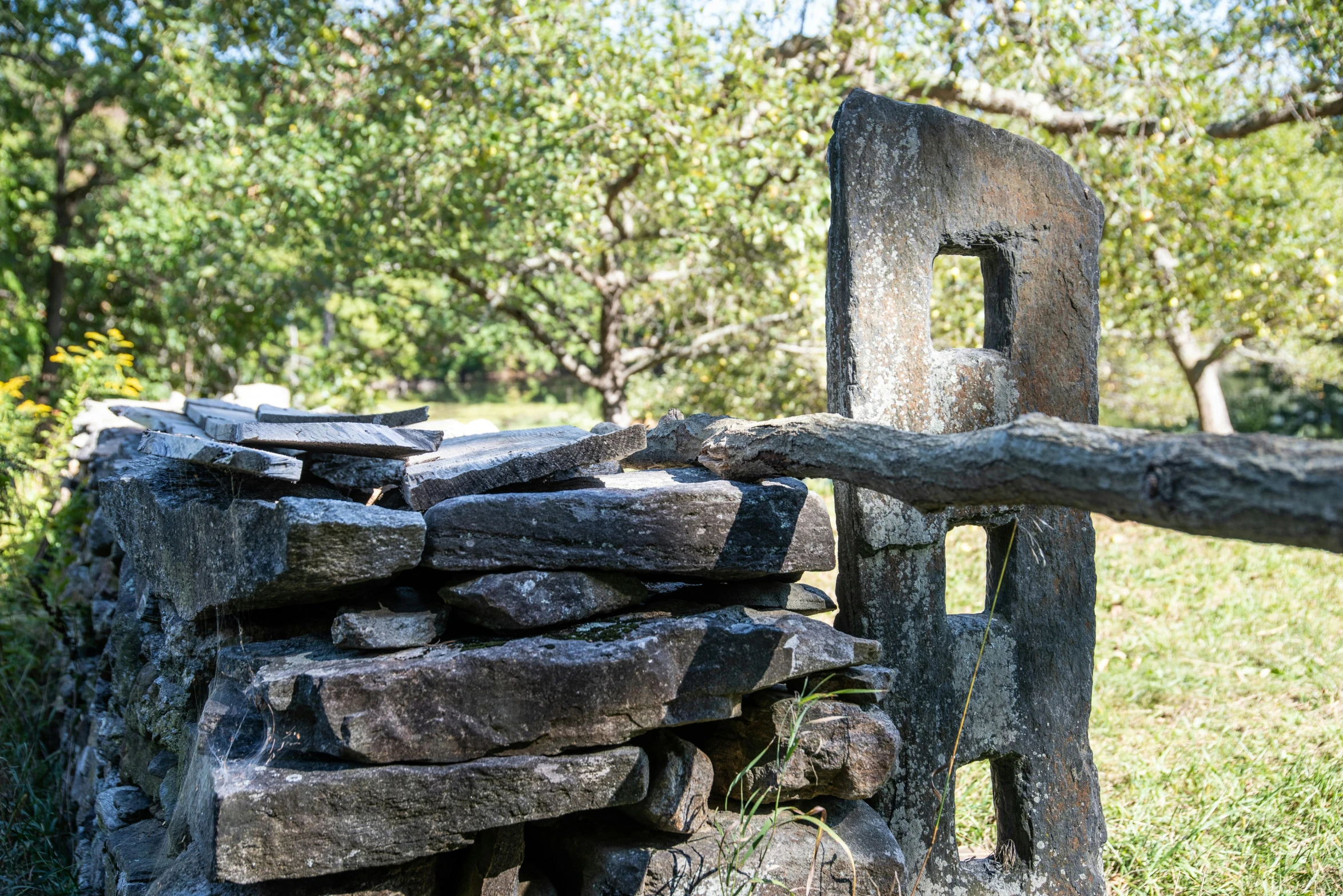 a large piece of wood on top of a stone wall