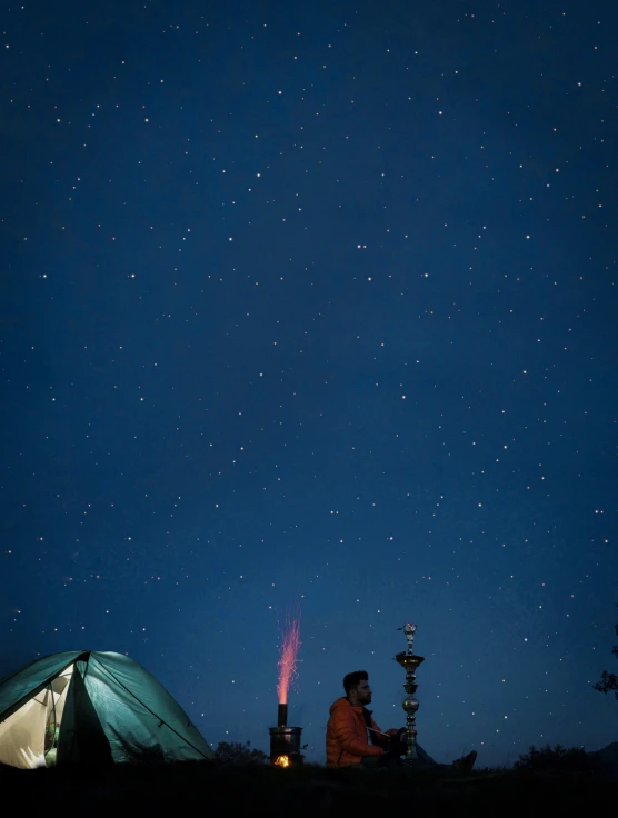 two people looking at the night sky over their tents