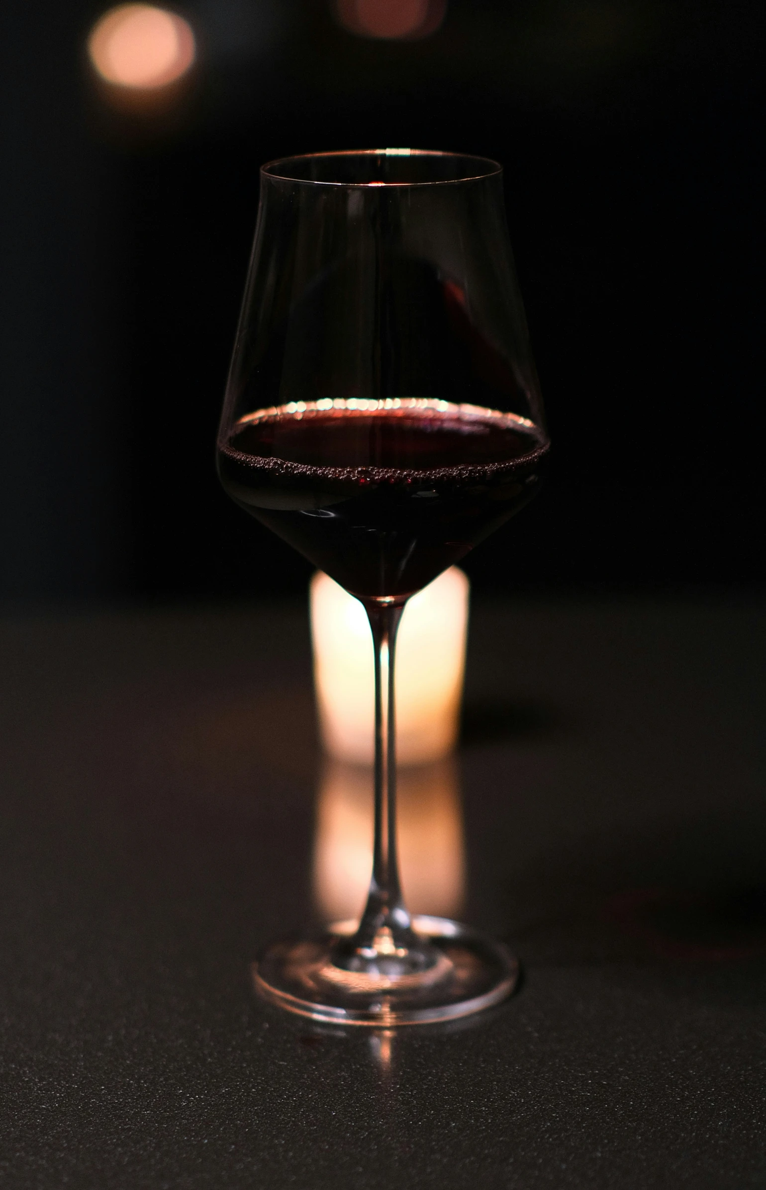 a glass of red wine is seen in this closeup