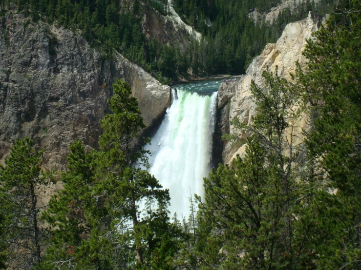 the view of a waterfall near some trees