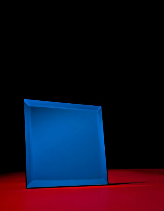 a red table with a blue square in the middle of it