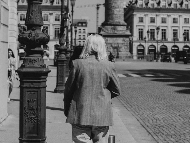 a person that is standing next to a pole