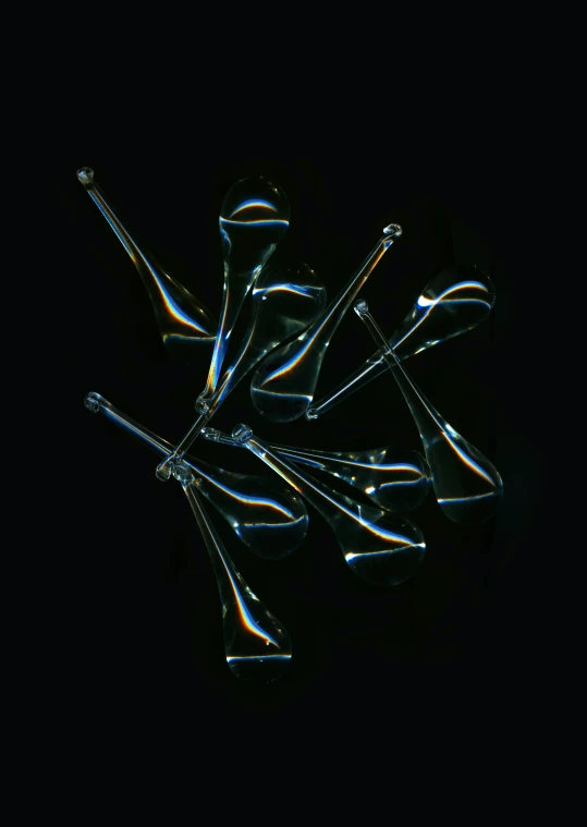 a black background with lots of glasses arranged around them