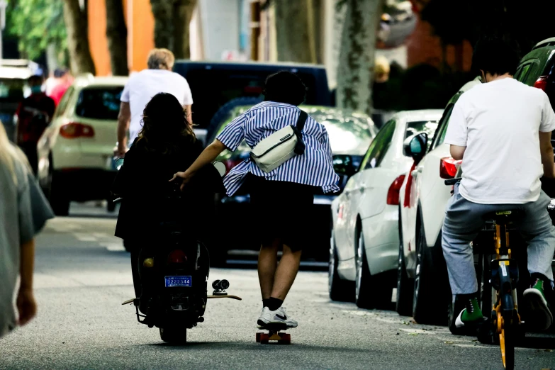 an image of a woman riding her motorcycle down the street