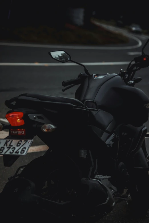 the motorcycle has been parked on the side of the street