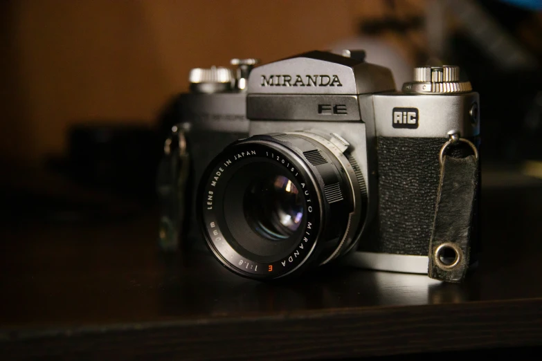 a silver and black camera on a table