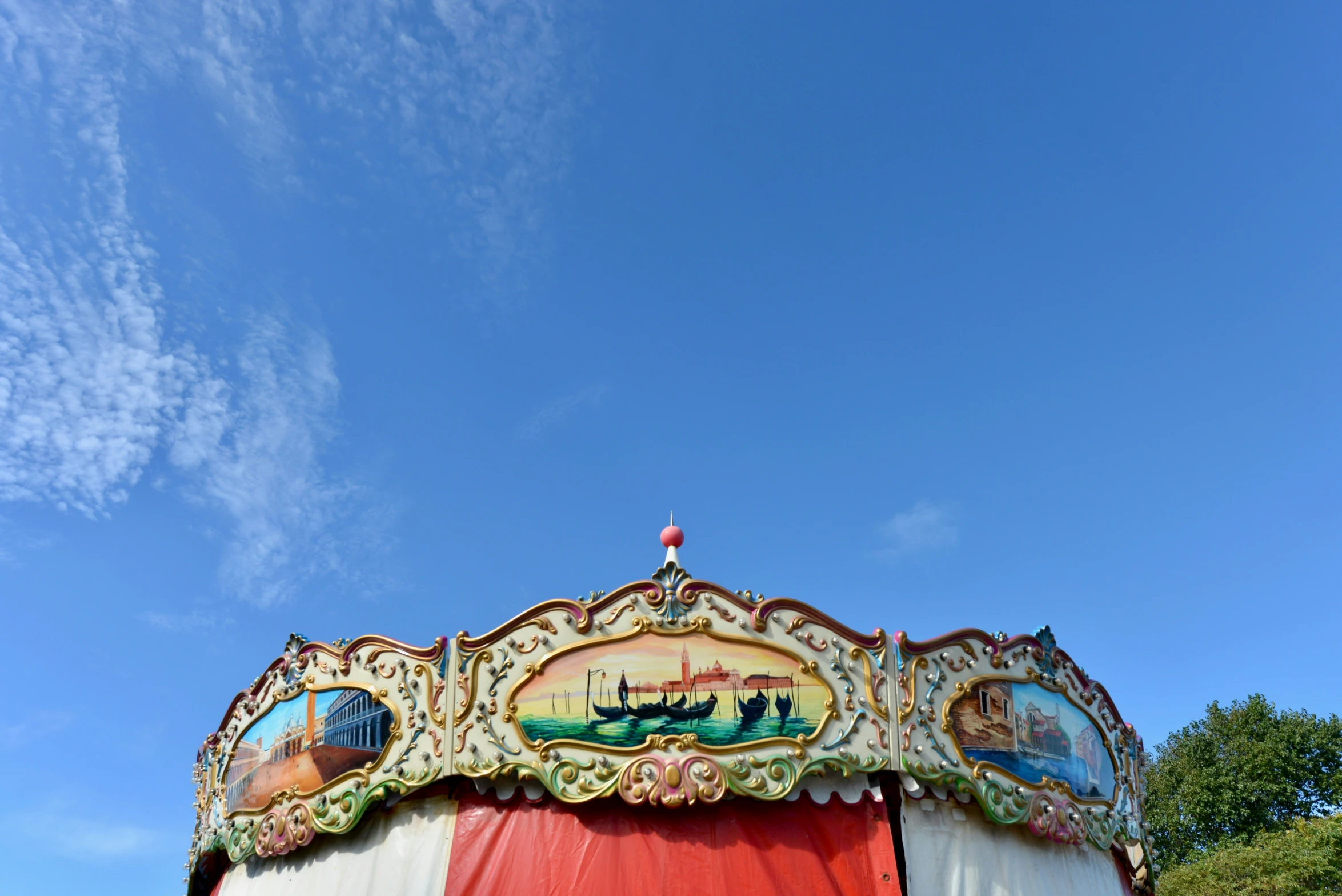 the carnival horse ride has painted on its top