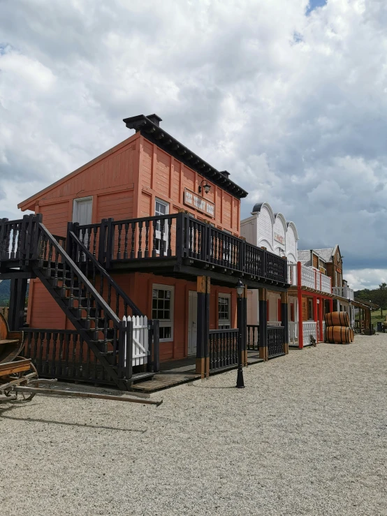 an old red building is shown with some black stairs