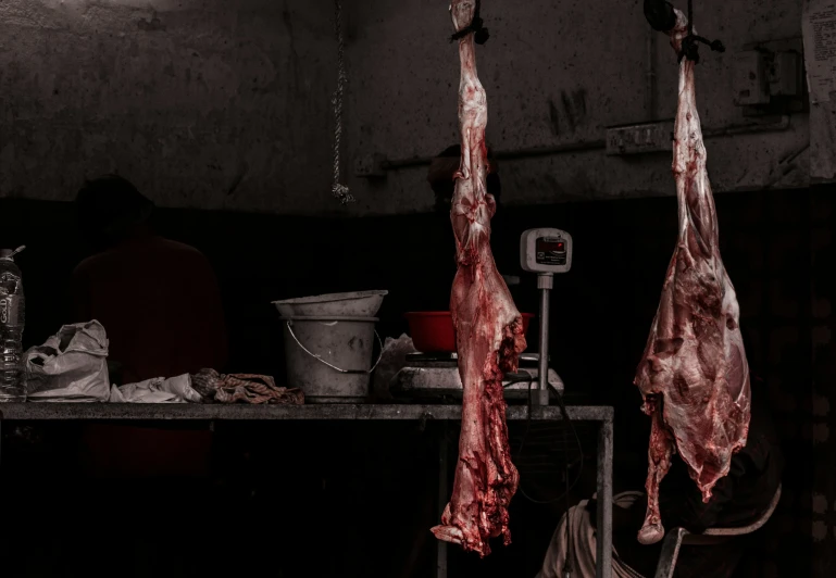 two dead meat hanging from a line on the ceiling of a room