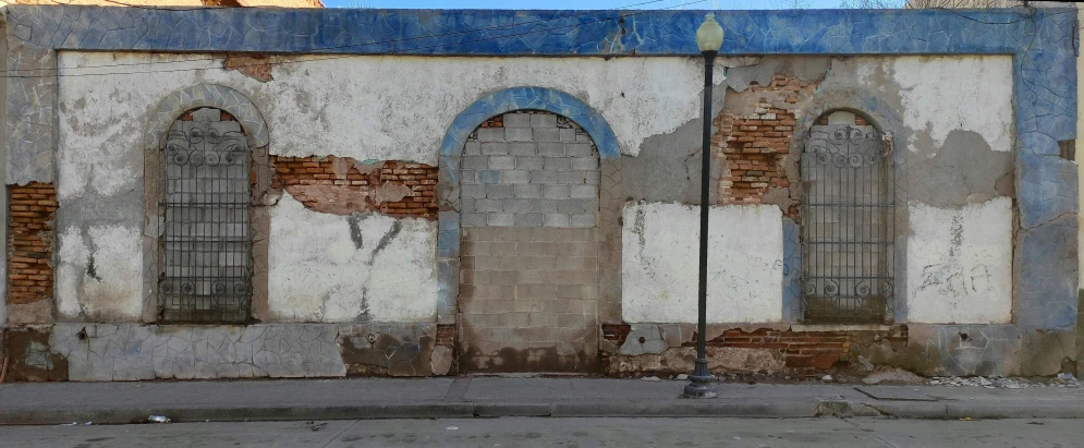 an old run down building with three windows